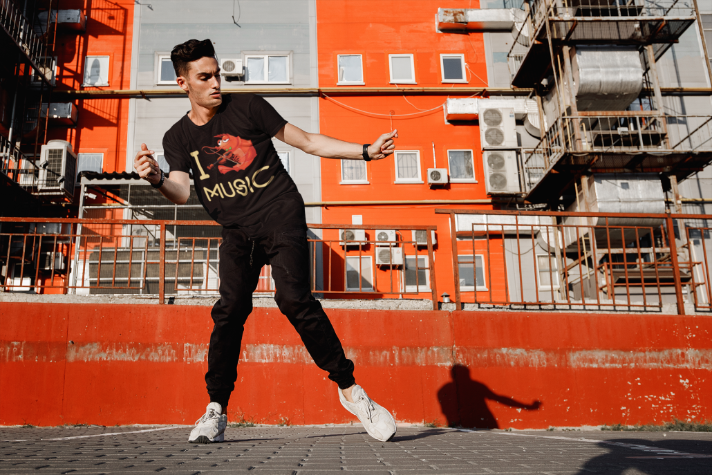 young guy dancing in a custom shirt in the hood
